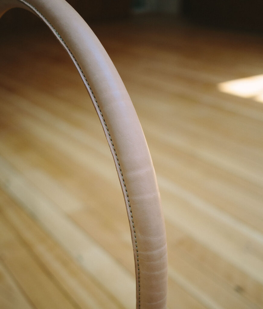 A vegetable tanned natural leather wrapped handrail